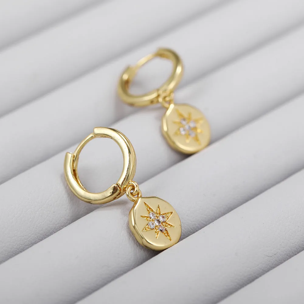E056 gold starburst dangle earrings